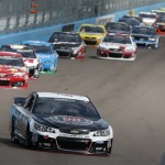  Kevin Harvick leads a group of cars into Turn 1 during the NASCAR Sprint Cup Series auto race Sunday, March 2, 2014, in Avondale, Ariz. (AP Photo/Ross D. Franklin)