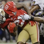 San Francisco 49ers running back Frank Gore (21) is tackled by Baltimore Ravens linebacker Dannell Ellerbe (59) in the first quarter of the NFL Super Bowl XLVII football game, Sunday, Feb. 3, 2013, in New Orleans. (AP Photo/Patrick Semansky)
