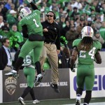 Marshall's Tommy Schuler, left, celebrates after scoring a touchdown with coach Mike Furrey in the first half of the Military Bowl NCAA college football game against Maryland, Friday, Dec. 27, 2013, in Annapolis, Md.(AP Photo/Gail Burton)