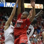  Texas Tech's Jaye Crockett (30) attempts to shoot for two as Arizona's Brandon Ashley, left, and Rondae Hollis-Jeffeerson (23) defend in the second half of an NCAA college basketball game on Tuesday, Dec. 3, 2013, in Tucson, Ariz. (AP Photo/John MIller)