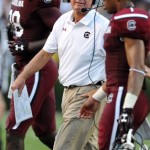 South Carolina head coach Steve Spurrier, center, talks to his team on the sidelines during the first half of an NCAA college football game against North Carolina, Thursday, Aug. 29, 2013, in Columbia, S.C. (AP Photo/Stephen Morton)