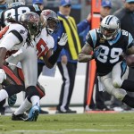 Carolina Panthers' Steve Smith (89) runs as Tampa Bay Buccaneers' Mark Barron (23) and Dekoda Watson (56) defend in the second half of an NFL football game in Charlotte, N.C., Sunday, Dec. 1, 2013. (AP Photo/Bob Leverone)