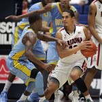  Arizona's Nick Johnson (13) is surrounded by Southern University's Christopher Hyder, front, and Malcolm Miller, back, as he tries to pass the ball in the second half of an NCAA college basketball game on Thursday, Dec. 19, 2013, in Tucson, Ariz. Arizona won 69-43. (AP Photo/John MIller)
