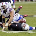 Arizona Cardinals quarterback Kevin Kolb, bottom, is injured after being hit by Buffalo Bills defensive end Chris Kelsay (90) during the second half of an NFL football game, on Sunday, Oct. 14, 2012, in Glendale, Ariz. Kolb left the game and the Bills went on to win 19-16 in overtime. (AP Photo/Rick Scuteri)