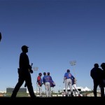 Players for the Chicago Cubs walk off the field after a spring training baseball game against the Texas Rangers on Wednesday, March 6, 2013, in Surprise, Ariz. The Rangers won 3-2. (AP Photo/Charlie Riedel)