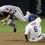 Arizona Diamondbacks' Aaron Hill, left, jumps after tagging second base before New York Mets' Marlon Byrd during the seventh inning of the baseball game at Citi Field, Monday, July 1, 2013, in New York. (AP Photo/Seth Wenig)