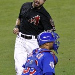 Arizona Diamondbacks' Chad Eaton, top, scores on an RBI single by teammate Aaron Hill as Chicago Cubs catcher Wellington Castillo waits for the throw during the second inning of a baseball game, Saturday, Sept. 29, 2012,in Phoenix. (AP Photo/Matt York)