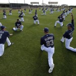 San Diego Padres players stretch during a baseball spring training workout Tuesday, Feb. 19, 2013, in Peoria, Ariz. (AP Photo/Charlie Riedel)