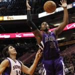 Sacramento Kings' Jason Thompson (34) gets the ball stripped by Phoenix Suns' Luis Scola (14), of Argentina, during the first half of an NBA preseason basketball game, Monday, Oct. 22, 2012, in Phoenix. (AP Photo/Ross D. Franklin)