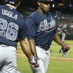 Atlanta Braves' Justin Upton, right, shakes hands with Dan Uggla after Upton scores a run against the Arizona Diamondbacks during the ninth inning of a baseball game, on Monday, May 13, 2013, in Phoenix. The Braves beat the Diamondbacks 10-1. (AP Photo/Ross D. Franklin)
