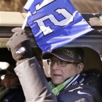 Seattle Seahawks owner Paul Allen waves a 12th Man flag out of his window as he rides in a parade for the NFL football Super Bowl champions Wednesday, Feb. 5, 2014, in Seattle. The Seahawks defeated the Denver Broncos 43-8 on Sunday. (AP Photo/Elaine Thompson)