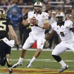 Central Florida quarterback Blake Bortles (5) looks to throw as teammate Storm Johnson (8) watches Baylor defensive back Sam Holl (25) during the first half of the Fiesta Bowl NCAA college football game, Wednesday, Jan. 1, 2014, in Glendale, Ariz. (AP Photo/Ross D. Franklin)