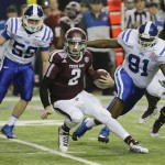  Texas A&M quarterback Johnny Manziel (2) is chased by Duke linebacker Kelby Brown (59) and nose tackle Jamal Bruce (91) in the first half of the Chick-fil-A Bowl NCAA college football game Tuesday, Dec. 31, 2013, in Atlanta. (AP Photo/Jamie Martin)