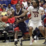 Duquesne's B.J. Monteiro (23) tries to dribble around Arizona's Jesse Perry (33) during the first half of an NCAA college basketball game at the McKale Center, Wednesday, Nov. 9, 2011, in Tucson, Ariz. (AP Photo/Wily Low)