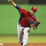 Puerto Rico's Mario Santiago delivers a pitch during a World Baseball Classic game against the United States at Marlins Park on Tuesday, March 12, 2013, in Miami. The United States defeated Puerto Rico 7-1. (AP Photo/Mike Ehrmann,Pool)