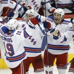 New York Rangers center Brad Richards (19) celebrates with teammates, from left, Ryan McDonagh, Brandon Prust and Mike Rupp after replay determined that Richards scored the game-winning goal against the Phoenix Coyotes in the final second of the third period of an NHL hockey game on Saturday, Dec. 17, 2011 in Glendale, Ariz. The Rangers won 3-2. (AP Photo/Paul Connors)