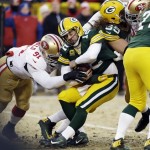  San Francisco 49ers defensive end Ray McDonald (91) tackles Green Bay Packers quarterback Aaron Rodgers (12) as the 49ers outside linebacker Aldon Smith, right, grabs Rodgers while fighting against the Packers offensive tackle David Bakhtiari (69) during the first half of an NFL wild-card playoff football game, Sunday, Jan. 5, 2014, in Green Bay, Wis. (AP Photo/Mike Roemer)