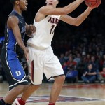  Arizona's Aaron Gordon, right, looks to pass while being guarded by Duke's Rodney Hood, left, during the first half of an NCAA college basketball game in the NIT Season Tip-off tournament championship on Friday, Nov. 29, 2013, in New York. (AP Photo/Jason DeCrow)