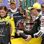 Kevin Harvick, right, sprays Madison Martin with champagne in Victory Lane after Harvick won the NASCAR Sprint Cup Series auto race Sunday, March 2, 2014, in Avondale, Ariz. (AP Photo/Ross D. Franklin)