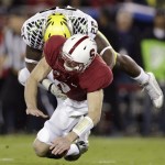  Oregon linebacker Derrick Malone (22) tackles Stanford quarterback Kevin Hogan after Hogan passed the ball during the first quarter of an NCAA college football game in Stanford, Calif., Thursday, Nov. 7, 2013. (AP Photo/Marcio Jose Sanchez)