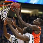 Michigan State's Derrick Nix, left, and Draymond Green, lower right, vie for possession of the ball with Louisville's Gorgui Dieng during the first half of a NCAA men's college basketball tournament West Regional semifinal on Thursday, March 22, 2012, in Phoenix. (AP Photo/Matt York)