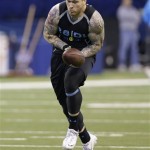 UCLA defensive lineman Cassius Marsh drops the ball during a drill at the NFL football scouting combine in Indianapolis, Monday, Feb. 24, 2014. (AP Photo/Nam Y. Huh)