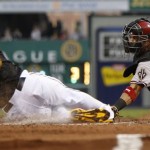 Pittsburgh Pirates' Andrew McCutchen (22) slides past Arizona Diamondbacks catcher Wil Nieves, right, to score from second on a hit by Pedro Alvarez in the third inning of a baseball game on Friday, Aug. 16, 2013, in Pittsburgh. (AP Photo/Keith Srakocic)