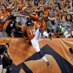 Denver Broncos wide receiver Andre Caldwell (12) is congratulated by fans after his touchdown against the Baltimore Ravens during the second half of an NFL football game, Thursday, Sept. 5, 2013, in Denver. (AP Photo/Jack Dempsey)