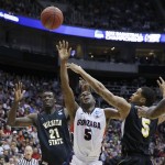 Gonzaga's Gary Bell shoots between Wichita State's Demetric Williams, right, and Ehimen Orukep during the first half during a third-round game in the NCAA men's college basketball tournament in Salt Lake City on Saturday, March 23, 2013. (AP Photo/George Frey)
