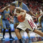  Arizona's Brandon Ashley, front, drives the lane against Southern University's Frank Snow, back,in the first half of an NCAA college basketball game on Thursday, Dec. 19, 2013, in Tucson, Ariz. (AP Photo/John MIller)