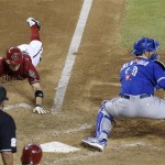 Arizona Diamondbacks' Tony Campana, top left, slides into home plate to score a run as Toronto Blue Jays' J.P. Arencibia waits for a late throw and umpire Hunter Wendelstedt watches during the seventh inning of a baseball game, Wednesday, Sept. 4, 2013, in Phoenix. (AP Photo/Ross D. Franklin)