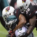 Philadelphia Eagles wide receiver DeSean Jackson, left, is tackled shy of the end zone by Arizona Cardinals safeties Kerry Rhodes, center, and James Sanders, right, to prevent a touchdown in the second quarter of an NFL football game on Sunday, Sept. 23, 2012, in Glendale, Ariz. (AP Photo/Paul Connors)