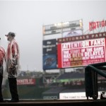 Members of the Washington Nationals' security crew stand on the field in ponchos during a rain delay before a baseball game between the Washington Nationals and Arizona Diamondbacks at Nationals Park, Thursday, June 27, 2013, in Washington.(AP Photo/Pablo Martinez Monsivais)