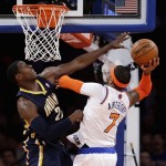 New York Knicks' Carmelo Anthony, right, goes up for a shot against Indiana Pacers' Paul George in the first half of Game 5 of an Eastern Conference semifinal in the NBA basketball playoffs, at Madison Square Garden in New York, Thursday, May 16, 2013. (AP Photo/Julio Cortez)
