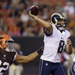 St. Louis Rams quarterback Sam Bradford (8) passes in the grasp of Cleveland Browns defensive tackle Desmond Bryant (92) in the first quarter of a preseason NFL football game, Thursday, Aug. 8, 2013, in Cleveland. (AP Photo/Tony Dejak)