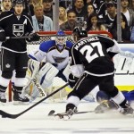 Los Angeles Kings defenseman Alec Martinez (27) maneuvers for a shot on goal as St. Louis Blues goalie Brian Elliott (1) defends in the first period of Game 4 of the NHL Western Conference Stanley Cup hockey playoff series in Los Angeles, Monday, May 6, 2013. (AP Photo/Reed Saxon)