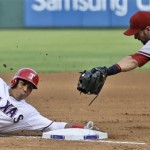 Texas Rangers' Leonys Martin, left, is tagged out at third base against Arizona Diamondbacks third baseman Eric Chavez (12) during the fourth inning of a baseball game Thursday, Aug. 1, 2013, in Arlington, Texas. Martin was trying to stretch his RBI double that scored teammates Jurickson Profar and Mitch Moreland when he was caught off base on the slide into third. (AP Photo/LM Otero)