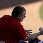 A fan catches a ball tossed into the stands during the sixth inning of an exhibition spring training baseball game between the Texas Rangers and the Chicago Cubs Wednesday, March 6, 2013, in Surprise, Ariz. (AP Photo/Charlie Riedel)