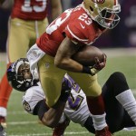 Baltimore Ravens cornerback Corey Graham (24) pulls down San Francisco 49ers running back LaMichael James (23) in the second quarter of the NFL Super Bowl XLVII football game, Sunday, Feb. 3, 2013, in New Orleans. (AP Photo/Dave Martin)