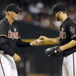Arizona Diamondbacks manager Kirk Gibson, left, pulls starting pitcher Ian Kennedy from the game against the Los Angeles Dodgers during the sixth inning of a baseball game, Tuesday, July 9, 2013, in Phoenix. (AP Photo/Matt York)