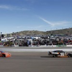 Nelson Piquet Jr., right, and Eric McClure, left, negotiate Turn 1 during the NASCAR Nationwide Series auto race Saturday, March 2, 2013, at Phoenix International Raceway in Avondale, Ariz. (AP Photo/Paul Connors)