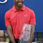 Tiger Woods smiles as he holds the trophy after winning The Players Championship golf tournament at TPC Sawgrass, Sunday, May 12, 2013, in Ponte Vedra Beach, Fla. (AP Photo/Gerald Herbert)