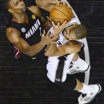 Miami Heat's Chris Bosh and San Antonio Spurs' Tim Duncan go after a rebound during the second half of Game 4 of the NBA Finals basketball series, Thursday, June 13, 2013, in San Antonio. (AP Photo/Larry W. Smith, Pool)
