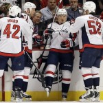 Washington Capitals' Mikhail Grabovski (84), second from right, celebrates with teammates after scoring a goal during the second period of an NHL hockey game against the Chicago Blackhawks in Chicago, Tuesday, Oct.1, 2013. (AP Photo/Nam Y. Huh)
