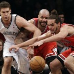 Brooklyn Nets center Brook Lopez (11), Chicago Bulls forward Carlos Boozer, center, and center Joakim Noah, right, compete for a loose ball in the first half of Game 5 of their first-round NBA basketball playoff series, Monday, April 29, 2013, in New York. (AP Photo/Kathy Willens)