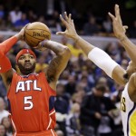 Atlanta Hawks forward Josh Smith (5) shoots over Indiana Pacers forward David West in the first half of Game 2 of a first-round NBA basketball playoff series in Indianapolis, Wednesday, April 24, 2013. (AP Photo/Michael Conroy)
