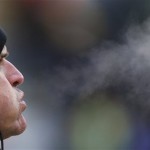  Steam comes out of the mouth of San Francisco 49ers head coach Jim Harbaugh as he watches warm ups before an NFL wild-card playoff football game against the Green Bay Packers, Sunday, Jan. 5, 2014, in Green Bay, Wis. (AP Photo/Jeffrey Phelps)