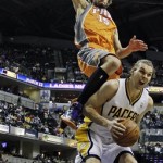 Phoenix Suns' Robin Lopez falls on Indiana Pacers' Louis Amundson as he attempts to shoot during the second half of an NBA basketball game, Friday, March 23, 2012, in Indianapolis. Phoenix won 113-111. (AP Photo/Darron Cummings)