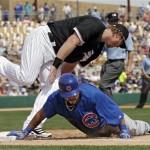 Chicago Cubs' Dioner Navarro dives back to first under Chicago White Sox first baseman Adam Dunn after an RBI single in the fourth inning of an exhibition spring training baseball game Friday, March 15, 2013, in Glendale, Ariz. (AP Photo/Mark Duncan)