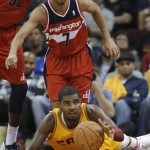 Cleveland Cavaliers' Kyrie Irving grabs a loose ball in front of Washington Wizards' Jannero Pargo (7) during the third quarter of an NBA basketball game Tuesday, Oct. 30, 2012, in Cleveland. Trving scored 29 points to lead the Cavaliers to a 94-84 win in the season opener. (AP Photo/Mark Duncan)